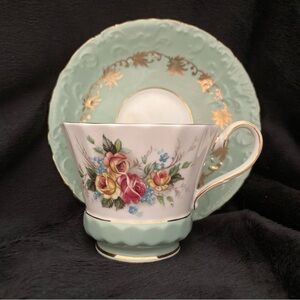 Aynsley fine English bone china teacup and saucer with floral design.
